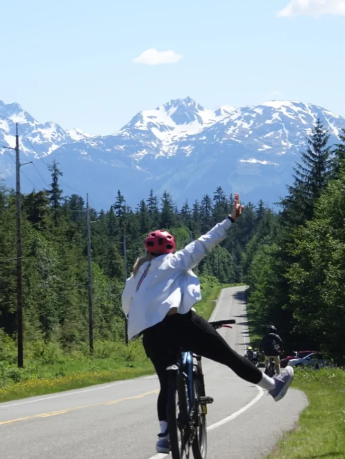 Your Ultimate Travel Guide to the Best Places to Visit in Alaska 3 Juneau alaska rainforest ebike mountain happy arms spread 3x4 1